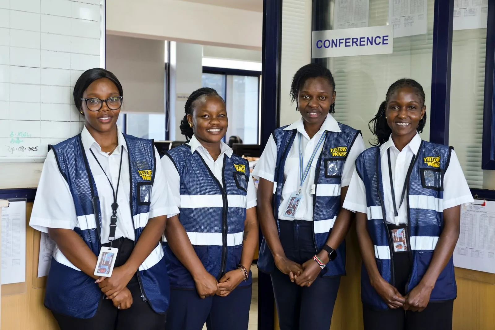 Four Yellow Wings office staff in the operations office at Wilson, March 2026