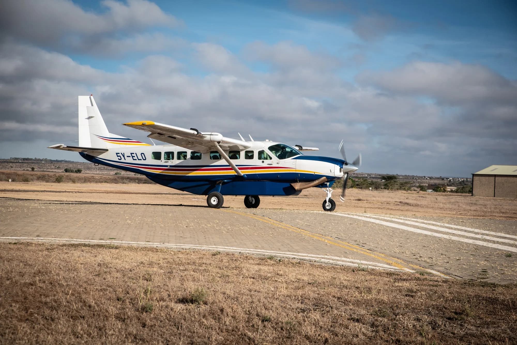 5Y-ELO taxiing on a murram strip.