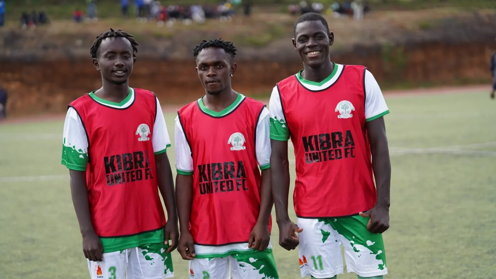 Kibra United: three players in kibra united bibs.