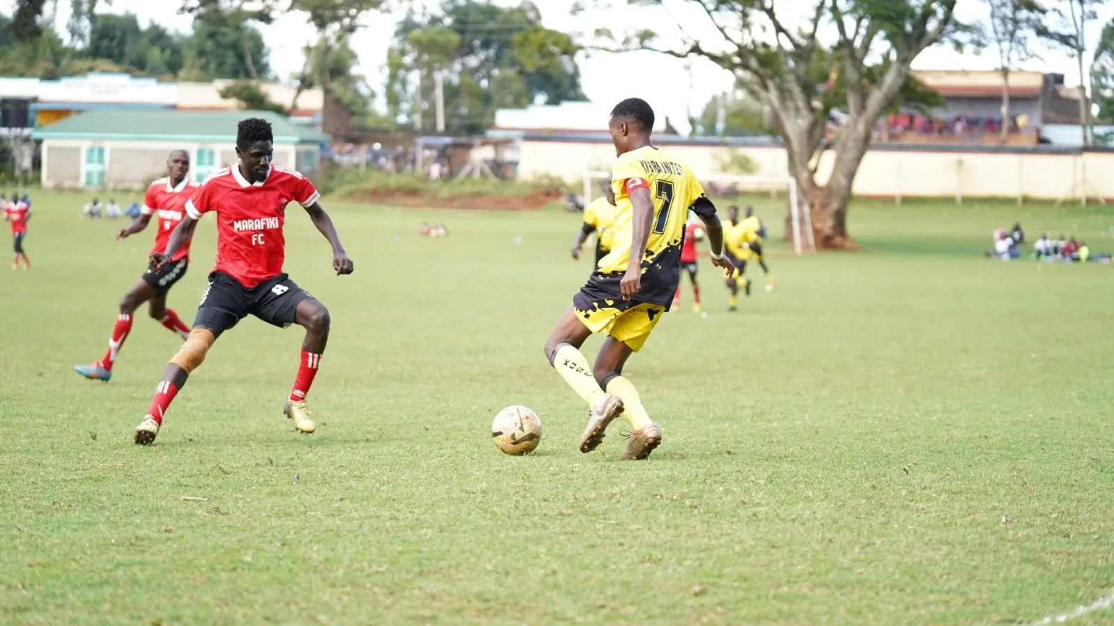 Kibra United: coaches in club shirts.