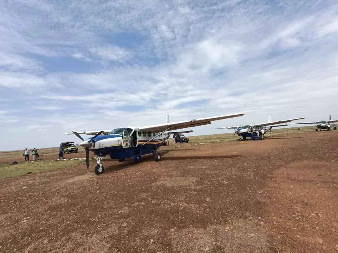 Yellow Wings Caravans parked on a red-earth bush strip under a wide sky