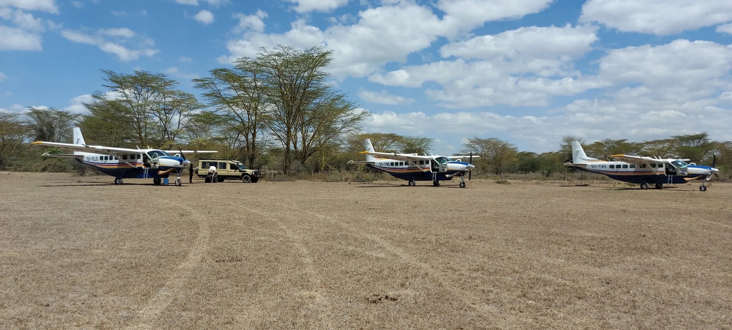 Yellow Wings Caravans on a dry bush strip under acacia trees