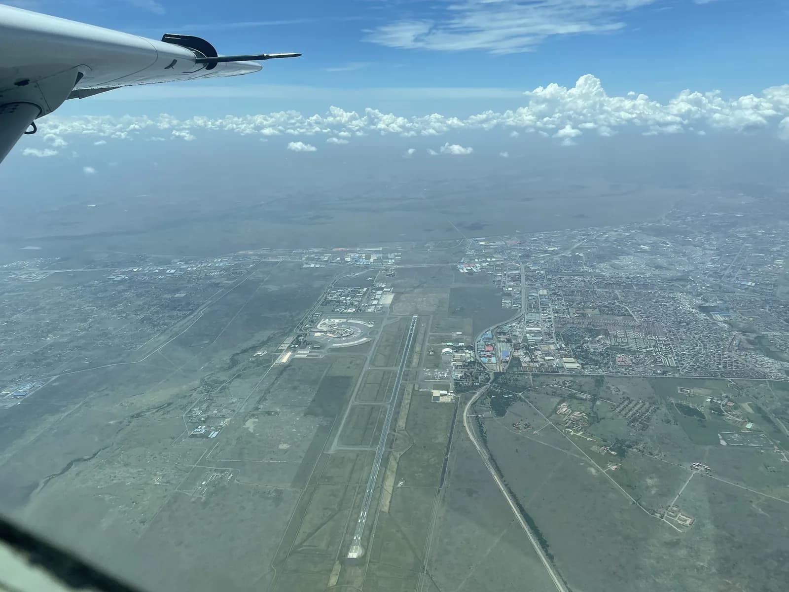 Jomo Kenyatta International Airport and Nairobi from the air, under the wing